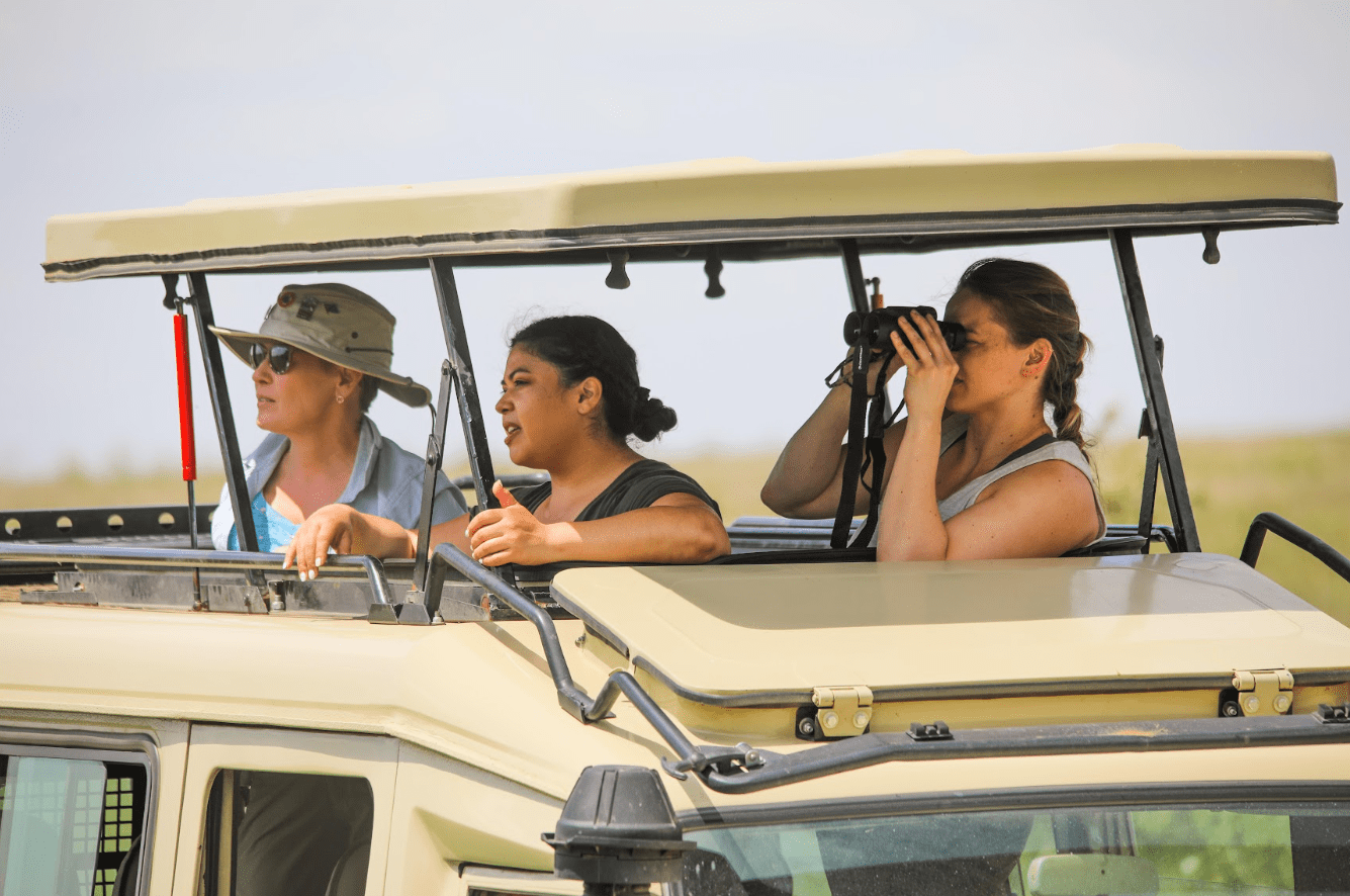 Tourist observing wildlife from a distance 