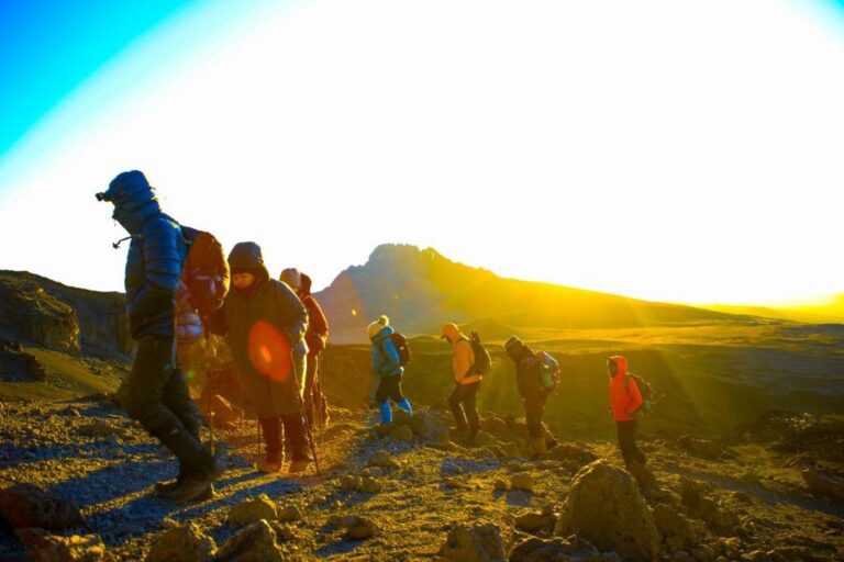 Group of travelers hiking across African highland terrain